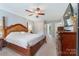 Spacious main bedroom with a four-poster bed, dresser, and view into an ensuite bathroom at 4000 Garfield Ct, Waxhaw, NC 28173