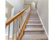 Carpeted staircase with white spindles and stained wood banister leading to the upper level at 4000 Garfield Ct, Waxhaw, NC 28173