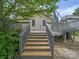 Back deck of a house with fresh wooden steps that leads to a well kept and well shaded backyard at 412 Dale Ave, Gastonia, NC 28052