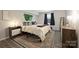 Cozy bedroom with natural light, stylish decor, and wood-look flooring at 4736 Hedgemore Dr, Charlotte, NC 28209