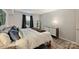 Comfortable bedroom features a plush bed, dresser, and window with natural light at 4736 Hedgemore Dr, Charlotte, NC 28209