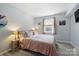 Inviting bedroom with soft lighting, a comfortable bed, and a peaceful ambiance at 4736 Hedgemore Dr, Charlotte, NC 28209