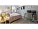 Cozy bedroom with a desk, a comfortable bed, and ample lighting for a relaxing space at 4736 Hedgemore Dr, Charlotte, NC 28209