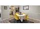 Cozy dining area features four yellow chairs, hardwood floors and access to the kitchen at 4736 Hedgemore Dr, Charlotte, NC 28209
