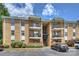 Well-maintained brick condo building with multiple balconies and parking at 4736 Hedgemore Dr, Charlotte, NC 28209