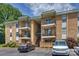 Attractive condo building with brick facade, multiple balconies, and ample parking at 4736 Hedgemore Dr, Charlotte, NC 28209