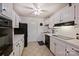 Efficient kitchen featuring white cabinets, tiled countertops, and essential appliances at 4736 Hedgemore Dr, Charlotte, NC 28209