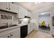 Well-lit kitchen features white cabinets, tile backsplash, and black appliances at 4736 Hedgemore Dr, Charlotte, NC 28209