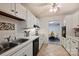 Efficient kitchen featuring white cabinets, tiled countertops, and stainless-steel sink at 4736 Hedgemore Dr, Charlotte, NC 28209