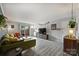 Bright living room offering stylish sofa, wood-look flooring, and easy access to outdoor living space at 4736 Hedgemore Dr, Charlotte, NC 28209