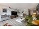 Spacious living room with modern decor, gray wood-look flooring, and stylish green sofa at 4736 Hedgemore Dr, Charlotte, NC 28209