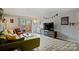 Comfortable living room with outdoor patio access featuring stylish sofa and wood-look floors at 4736 Hedgemore Dr, Charlotte, NC 28209