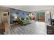 Inviting living room with comfortable seating, stylish green sofa, and access to a private patio at 4736 Hedgemore Dr, Charlotte, NC 28209