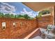 Cozy patio with brick privacy wall, elegant chairs, and serene outdoor view at 4736 Hedgemore Dr, Charlotte, NC 28209