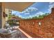 Charming patio with brick wall, stylish seating, and lovely outdoor view at 4736 Hedgemore Dr, Charlotte, NC 28209