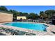 Sparkling community pool surrounded by lounge chairs and lush greenery at 4736 Hedgemore Dr, Charlotte, NC 28209