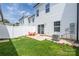 Fenced backyard with a small patio, grassy area, and flowerbed at 5008 Patton Dr, Gastonia, NC 28056