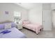 Bright bedroom features two twin beds with a window providing natural light at 5008 Patton Dr, Gastonia, NC 28056