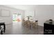 Open concept dining area with hardwood floors, a table, and a slider to the backyard at 5008 Patton Dr, Gastonia, NC 28056