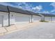 View of a row of townhome garages with white doors and black roofs at 5008 Patton Dr, Gastonia, NC 28056