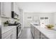Contemporary kitchen with white cabinets, stainless steel appliances, and quartz countertops at 5008 Patton Dr, Gastonia, NC 28056