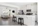 Stylish kitchen features white cabinetry, stainless steel appliances, and a breakfast bar that opens to the living area at 5008 Patton Dr, Gastonia, NC 28056