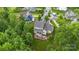 Aerial shot of a home with manicured lawn and stone patio surrounded by lush trees at 501 Preservation Dr, Fort Mill, SC 29715