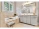 Bright bathroom featuring a soaking tub with tile surround and custom vanity with large mirror at 501 Preservation Dr, Fort Mill, SC 29715