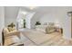 Bright, spacious bedroom with ensuite, light wood flooring, and cozy sitting area at 501 Preservation Dr, Fort Mill, SC 29715