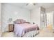 Cozy bedroom features a bed with a pink comforter, geometric accent wall, and soft lighting at 501 Preservation Dr, Fort Mill, SC 29715