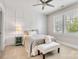 Bright bedroom with gray accents, decorative wall paneling, a ceiling fan, and natural light at 501 Preservation Dr, Fort Mill, SC 29715
