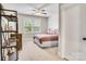 Bedroom featuring a neutral color palette, textured accent wall, ceiling fan, and natural light at 501 Preservation Dr, Fort Mill, SC 29715