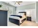 Comfortable bedroom with a navy upholstered bed, wood nightstand, and natural light at 501 Preservation Dr, Fort Mill, SC 29715