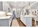 Modern kitchen with stainless steel appliances, white cabinets, and an island with bar seating at 501 Preservation Dr, Fort Mill, SC 29715