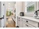 Bright kitchen showcasing stone countertops, custom cabinets, and views into the dining room at 501 Preservation Dr, Fort Mill, SC 29715