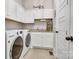 Laundry room with washer and dryer, ample cabinetry, and a convenient folding area at 501 Preservation Dr, Fort Mill, SC 29715