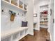 Mudroom with bench seating, storage cubbies, and convenient access to pantry at 501 Preservation Dr, Fort Mill, SC 29715