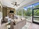 Cozy screened porch with a stone fireplace and comfortable seating, perfect for enjoying the outdoors at 501 Preservation Dr, Fort Mill, SC 29715