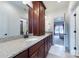 Bathroom featuring double vanity, granite countertop, wood cabinets, and connecting doors at 512 Appomatox Dr, Marvin, NC 28173