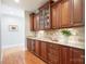 Butler's pantry showcases custom cabinetry, granite countertops, tile backsplash and hardwood floors at 512 Appomatox Dr, Marvin, NC 28173