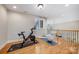 Well-lit exercise room featuring a Peloton bike, yoga mat, and hardwood floors at 512 Appomatox Dr, Marvin, NC 28173