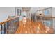Upstairs hallway with wood floors and wrought iron railing at 512 Appomatox Dr, Marvin, NC 28173