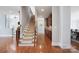Welcoming hallway with beautiful staircase and wood floors at 512 Appomatox Dr, Marvin, NC 28173