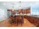 Kitchen island with seating features wood accents, pendant lighting, stainless steel appliances, and hardwood floors at 512 Appomatox Dr, Marvin, NC 28173