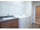 Bright laundry room with granite counters, sink, modern washer and dryer and ample storage at 512 Appomatox Dr, Marvin, NC 28173