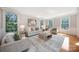 Bright living room with large windows, hardwood floors, neutral decor, and comfortable seating at 512 Appomatox Dr, Marvin, NC 28173