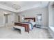 Spacious main bedroom boasts a tray ceiling, soft carpeting and a seating bench at the foot of the bed at 512 Appomatox Dr, Marvin, NC 28173