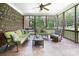 Inviting screened porch with ceiling fan, comfortable seating, and brick accents at 512 Appomatox Dr, Marvin, NC 28173