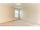 Bright, carpeted bedroom with a window letting in natural light at 5205 Raging Creek Dr # 122, Indian Trail, NC 28079