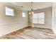 Spacious dining room featuring modern light fixture and large windows at 5205 Raging Creek Dr # 122, Indian Trail, NC 28079